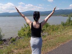 absolutely beautiful back View of Woman on lake coast