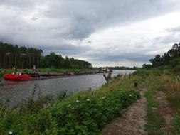 red boat on the river in the distance