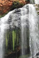 waterfall with leaves and rocks