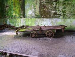 iron cart at the green wall