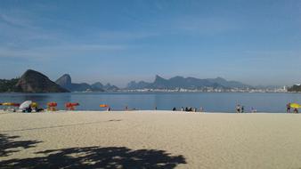 A cozy beach with people by the lake