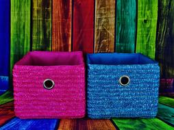 pink and blue basket near colored wall