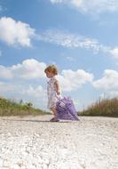 child with a purple umbrella