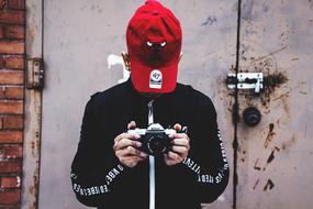 Person with Nikon Camera red hat