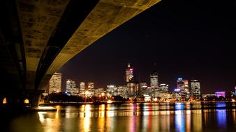 night panorama of the modern city view from under the bridge