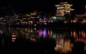 brightly colored streets with lanterns by the water