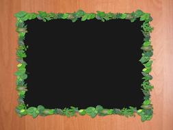 blank black picture frame on board