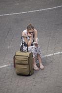 girl is waiting with a suitcase