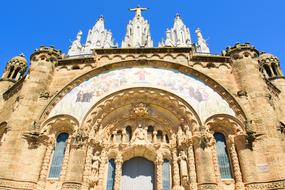 Beautiful, colorful and decorated Cathedral, at blue sky on background, in Spain