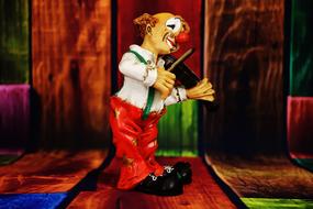 clown figure with violin