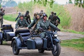 military personnel riding a motorcycle