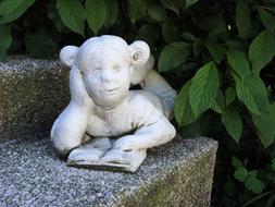 girl with a book as a stone statue