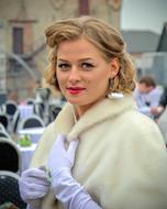 Beautiful Women wearing white coat and purple gloves in city