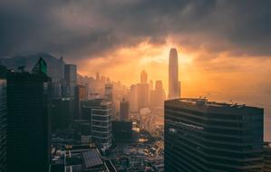 Beautiful architecture of the city at colorful sunset in clouds