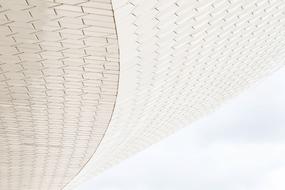 Beautiful bottom view of the white architecture at cloudy sky background