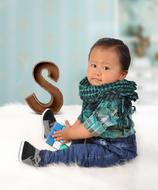 Child Sitting and Letter s