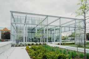 Beautiful glass building in the green and yellow garden