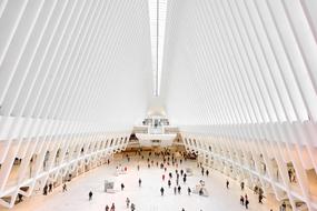 panoramic view of people in a huge white hall