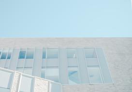 photo of a modern white building against a blue sky