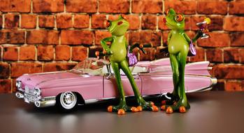 green frogs by the car