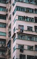 Condominium building with the green windows and colorful clothes