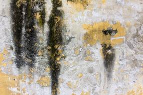 Texture of the old yellow wall with black paint