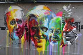 colored graffiti with faces on the wall