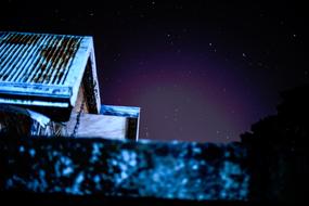 photo of the roof of the house against the night sky