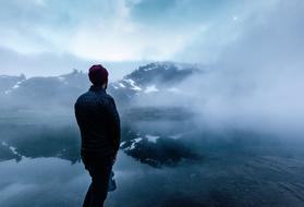 person Mountains water