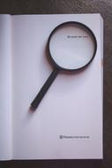 magnifying glass black library paper