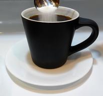 black mug with sugar