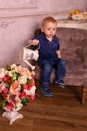 Baby Boy Watering flowers, Studio portrait