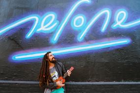 man with a musical instrument on a neon background