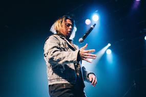 Man singing to stage microphone