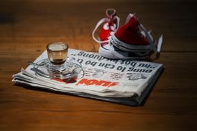 newspaper with a glass on the table