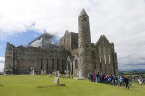 people walking by the castle