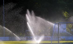 splashing water in the park by the field