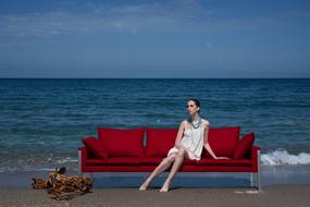 Model woman on red sofa