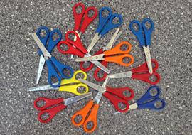 Scissors with colorful handles, on the ground