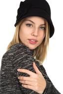 photo of blonde in a gray sweater and black hat