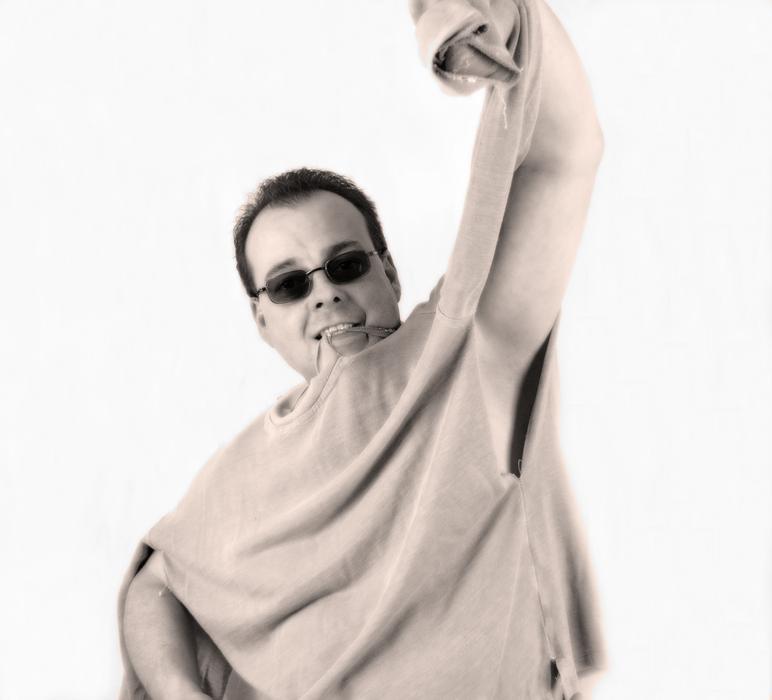 Man with sunglasses and in torn sweater at white background
