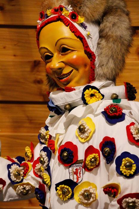 a scary clown in colored flowers