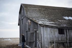 man and an old barn