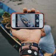 image of the boat on the smartphone screen in hand close-up