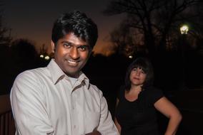 indian man and caucasian woman in park at night