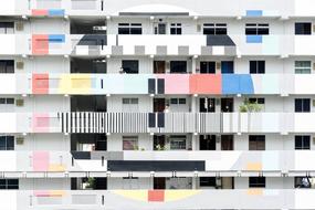 People on balconies of contemporary apartment building