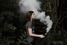 Lady with smoke in the forest