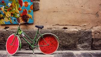 Wall Bike with red wheels on street