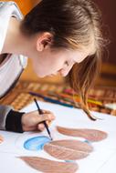 a painter draws a girlâs head with a pencil