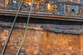 Colorful, old texture of the wood, with the peeling pain, and ropes